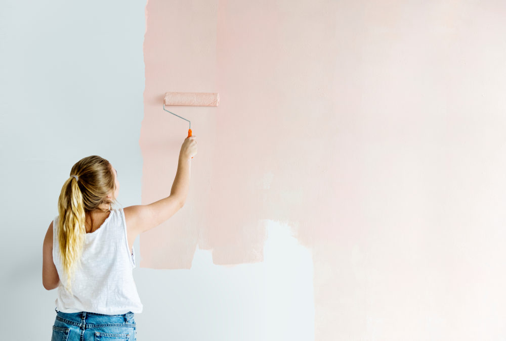 A girl painting a wall